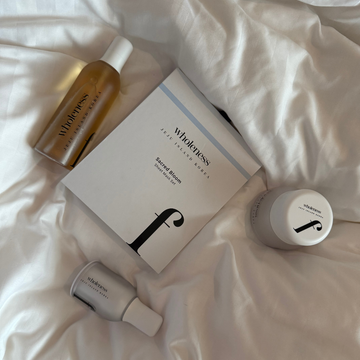 Close-up of two glass vials with liquid on a light gray background