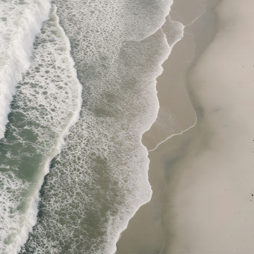 Crocheted bag with 'wholeness' text hanging on a wooden post by a beach.